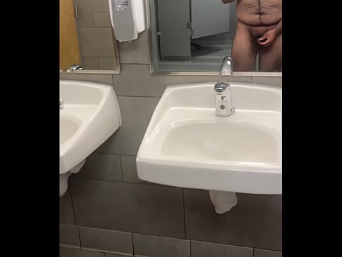 Jerking off completely nude in a public bathroom and cumming on the floor