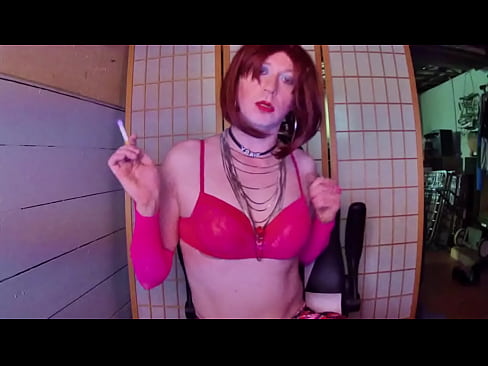 Redhead transvestite hooker Adrienne Velvet in pink bra smoking fetish