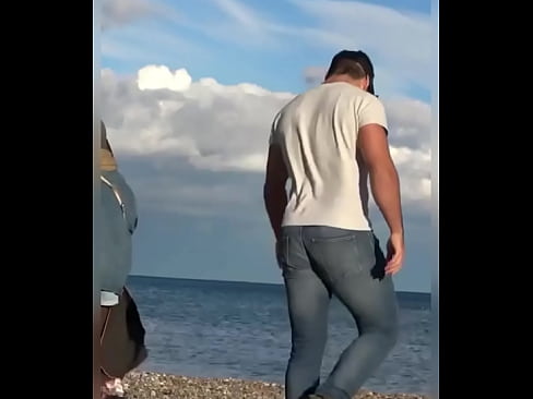 Tight wet jeans hunk walks into the sea