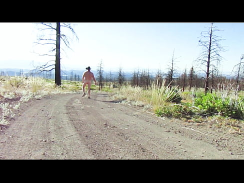 Naked walk on a dirt road.