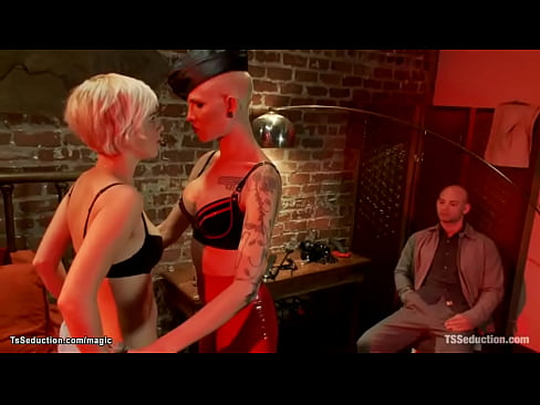 Tall tattooed big tits blonde shemale dominatrix Danni Daniels dominates and fucks kinky couple Chloe Camilla and Patrick Rouge In the Red Light District