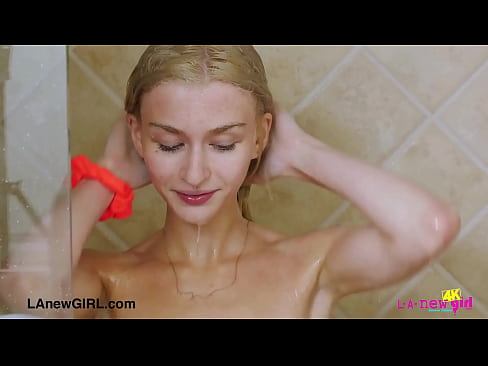 Radiant blonde beauty enjoys a sensual bath