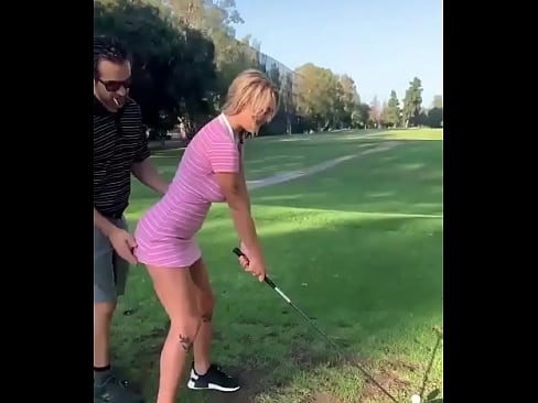 A girl plays golf
