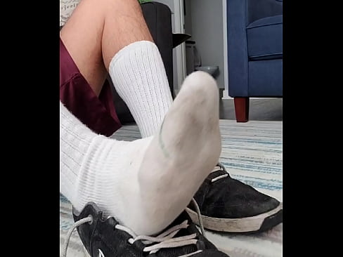 Sneaker and sock play. Dirty smelly soles