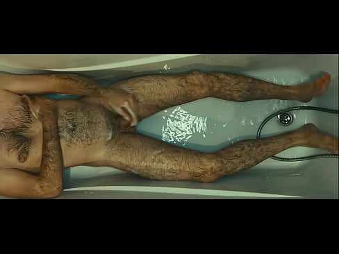 Hunk hairy man soaping himself and playing with urine in the white bath