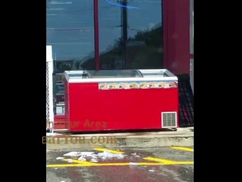 Gas Station Employee cleaning a cooler