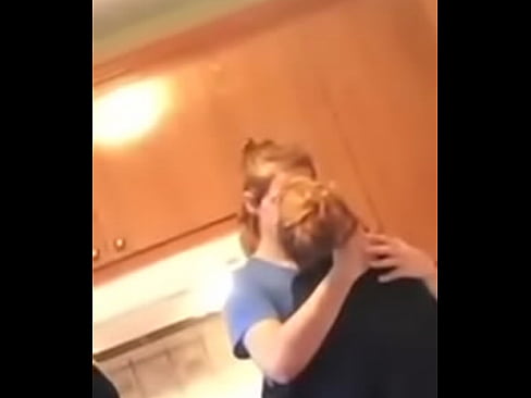 Lesbians kissing while their friend sees