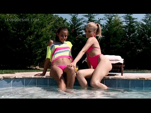 Lesbian teen duo kissing sensually by the pool