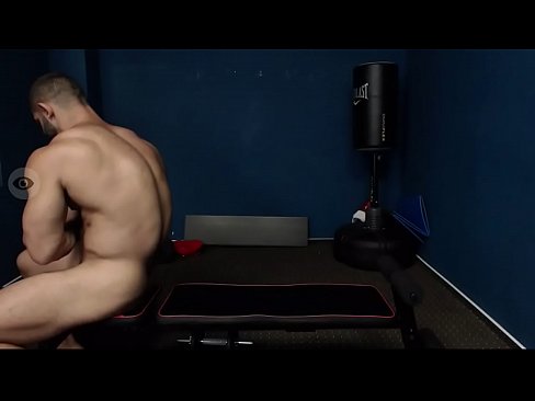 Naked guy lifting weights