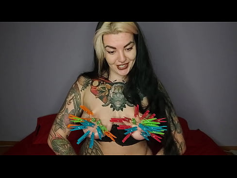 Tattooed, kinky girl hangs the maximum number of clothespins on her big tits