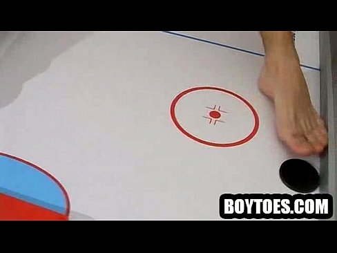 Stud tugs on his cock and plays air hockey with his feet