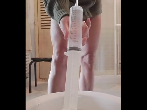 Anal enema with a big syringe.