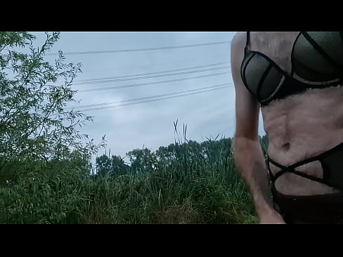 Man dressed in lingerie and masturbates outdoors