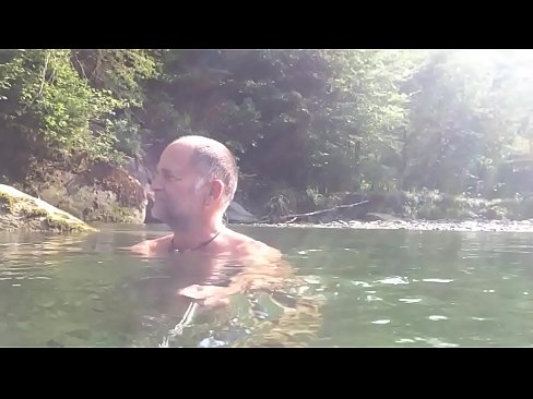 naturist enjoying watering the river