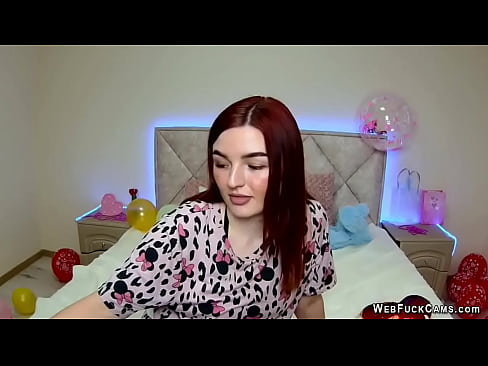 In a decorated bedroom with balloons redhead amateur babe NicolPot sitting in her bed dressed and chatting with fans on solo live webcam show