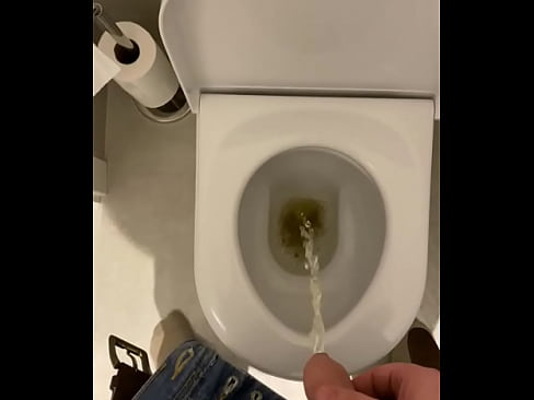 Uncut cock taking a piss into the toilet