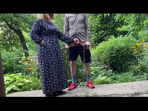 Mommy MILF pissing standing up in the city park after helping her stepson piss