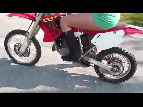 girl revving a dirtbike