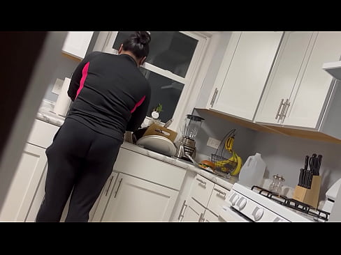 Latina Maid cleaning kitchen