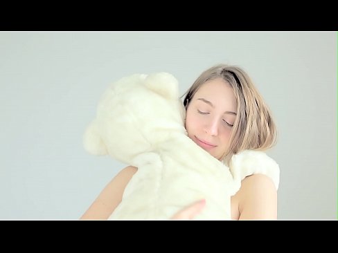Hot naked blonde cuddling her teddy bear