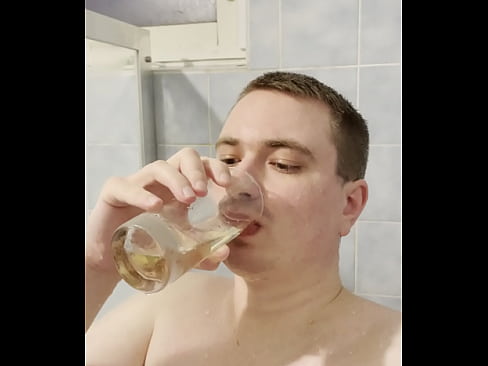 Teen boy taking pee from a glass