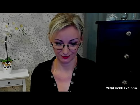 Beautiful blonde amateur German MILF LUXvanessa in orange mini skirt and black blouse flashes cleavage for her fans on live webcam show