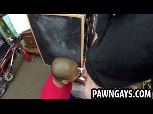 Ebony hunk sucking on two cocks at the pawn shop