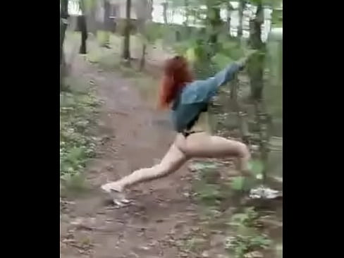 Sexy redheaded pussy walks through the woods almost naked