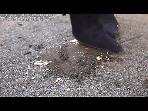 Woman trampling peanuts with legs