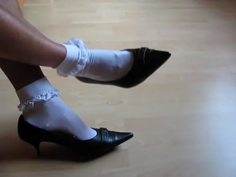 French shoe model presenting her leather high heels and frilly socks