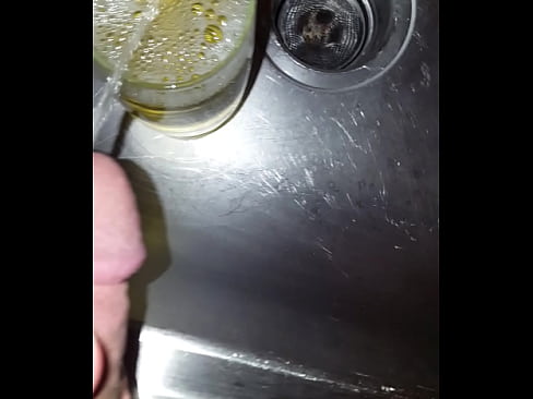 Strong golden piss into a cup