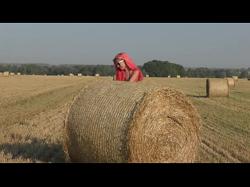 Bikini, hay rolls and field