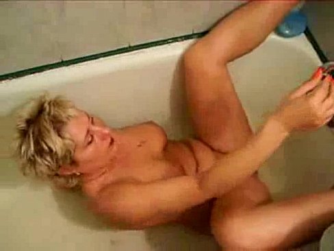 Mature masturbates in bathtub.