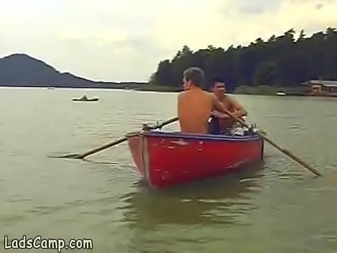 Hot boys rowing in a boat and sucking