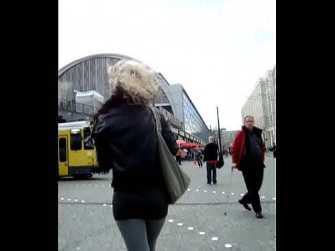 Candid girl in short skirt grey leggings and high heel ankle boots