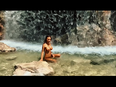 Monika Fox enjoys the beauty of the waterfall in the background
