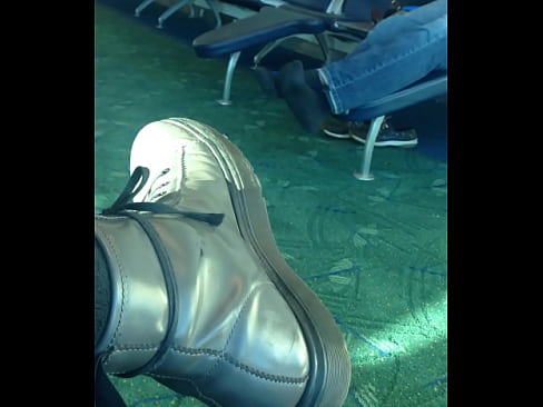 Mature man sockplay in airport terminal