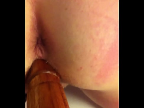 Fucking her with a wooden dildo