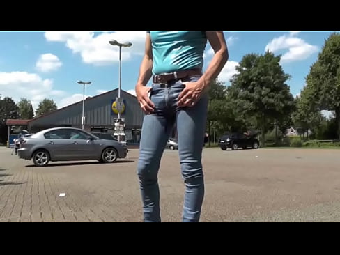 pissing in jeans in front of a supermarket