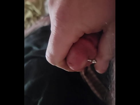 Stroking pierced cock