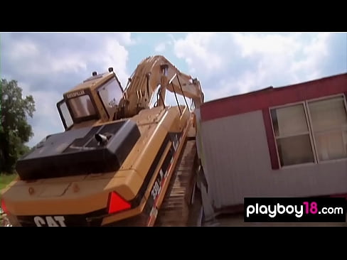 Busty nude beauties testing huge machines at a construction yard