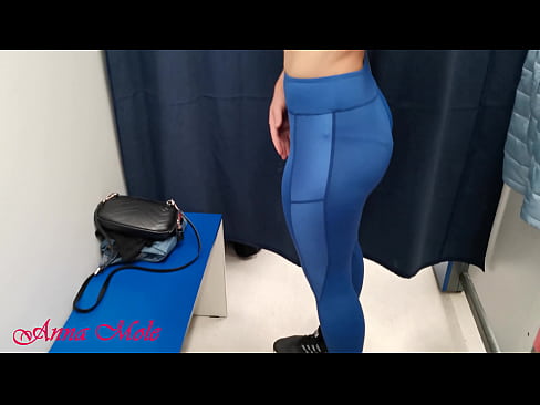 In the dressing room, a student tries on various pants for sports. Anna Mole