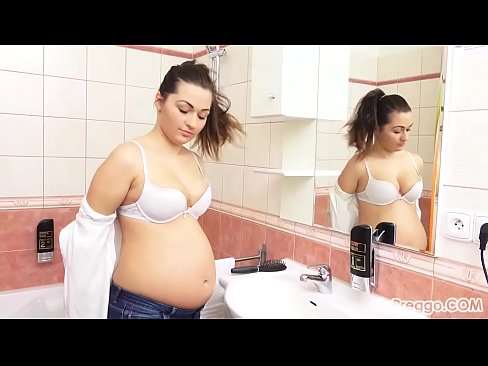Missy pauses to admire her pregnant body in the bathroom mirror!