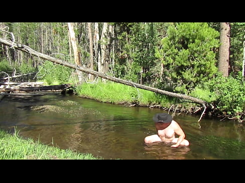 Naked in the stream.