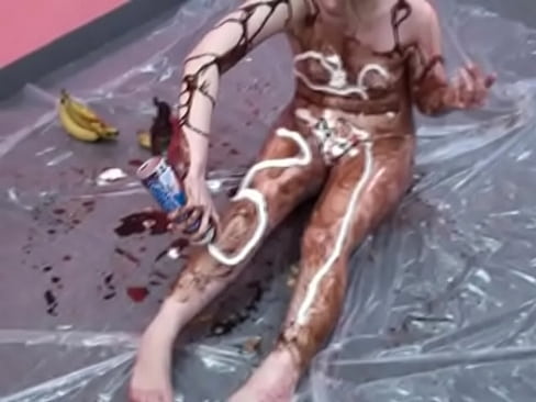 Veronica Snow gets covered in ketchup and poses for the camera on the floor