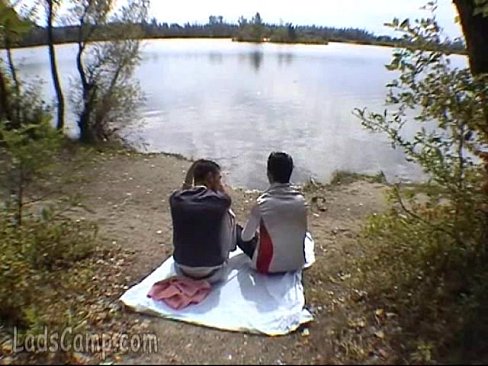 Two buddies go down on each other on a river bank