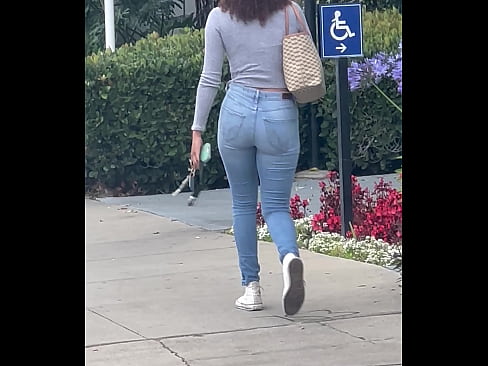 Young girl in jeans walking