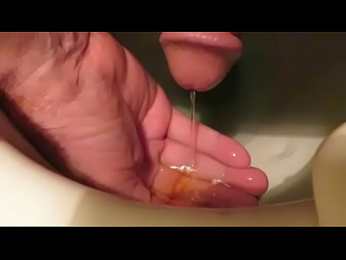 enjoying my warm piss and jacking my cock with my piss