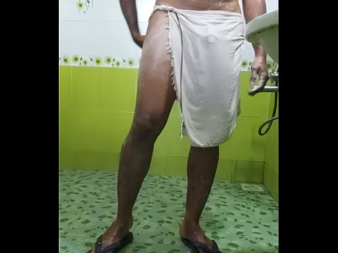 Indian boy in transparent towel taking shower in public