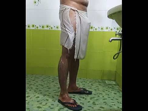 Indian boy in transparent towel taking shower in public